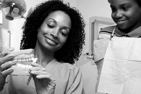 A dentist demonstrating how to brush teeth